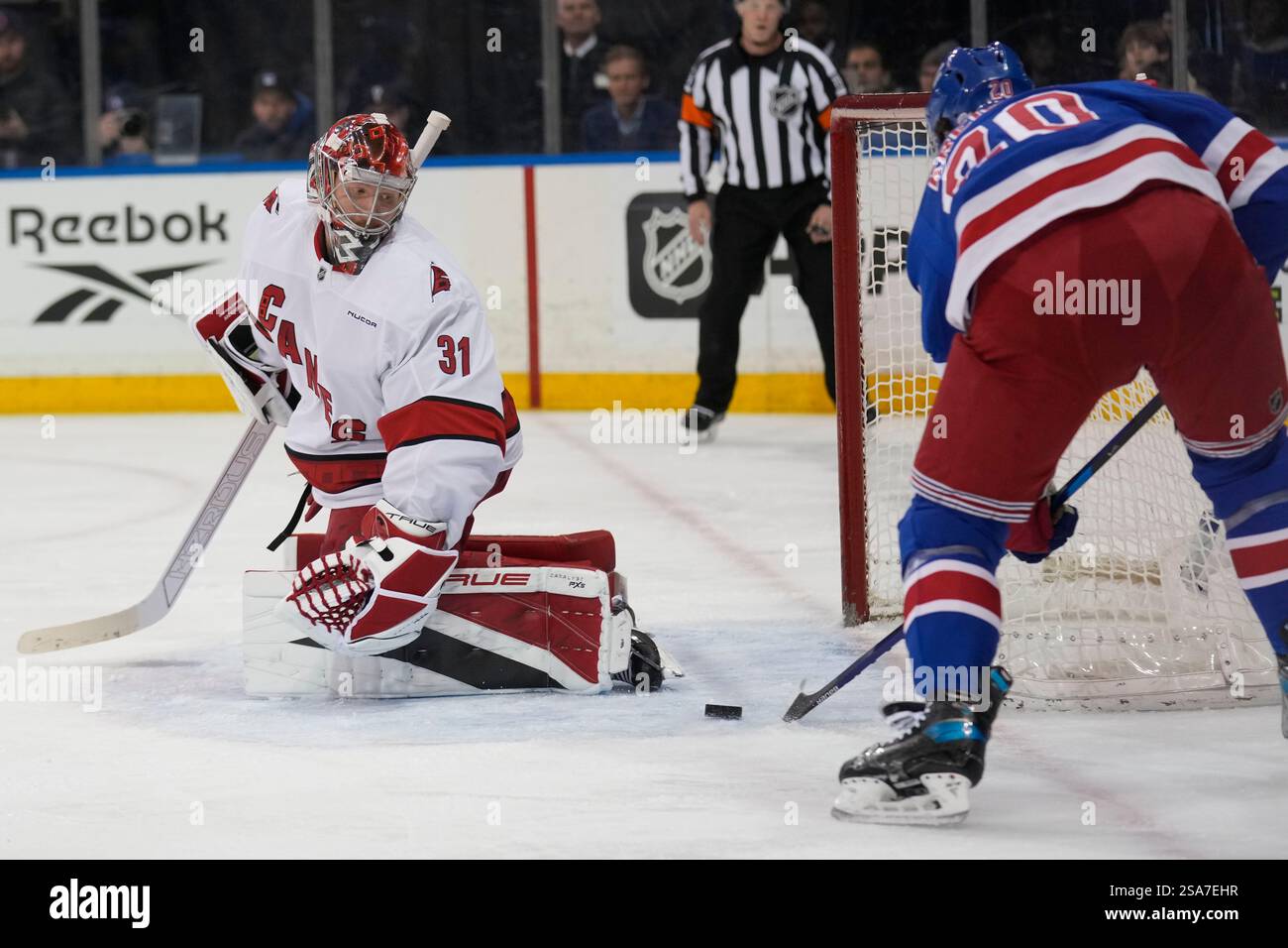 Carolina Hurricanes goaltender Frederik Andersen, left, looks as New
