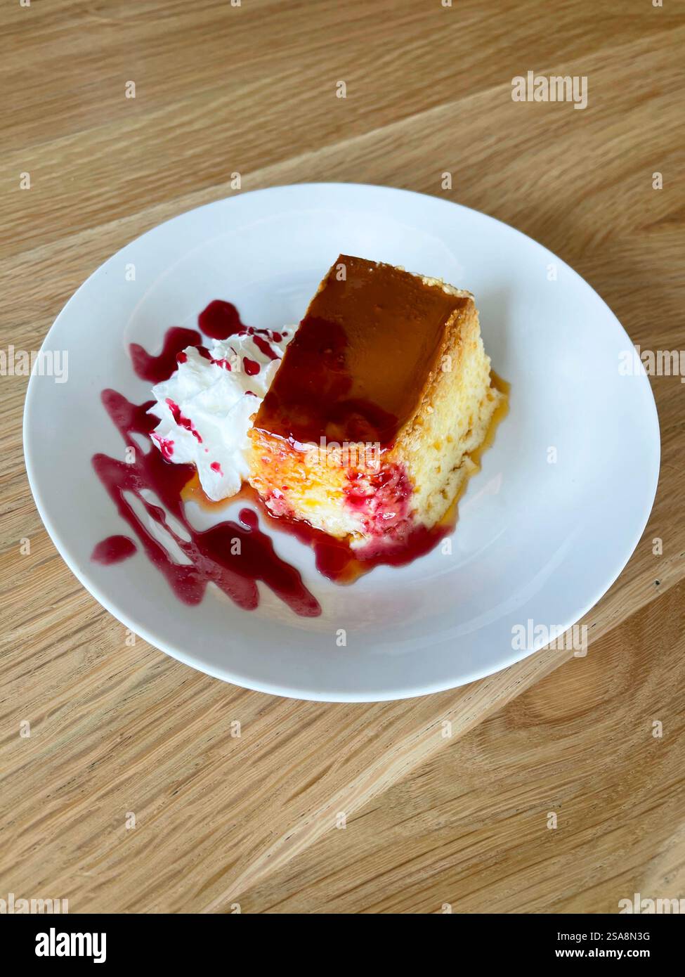 Cheese cake with raspberry syrup. - Smartphone Captured Stock Image
