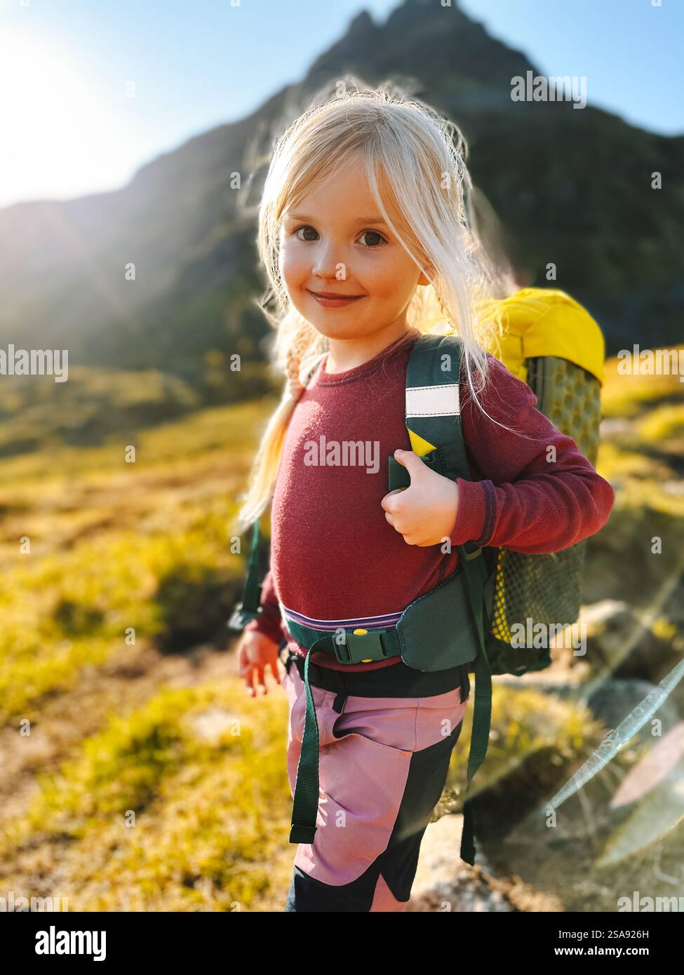 Child girl hiking with backpack family travel summer vacations outdoor, 4 years old kid climbing mountains active healthy lifestyle adventure trip Stock Photo