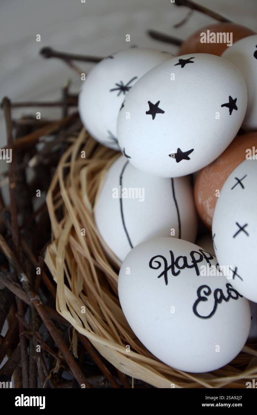 White marker decorated Easter eggs in the nest Stock Photo