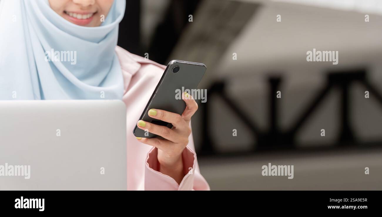 Muslim woman in hijab using smartphone for business communication and ...