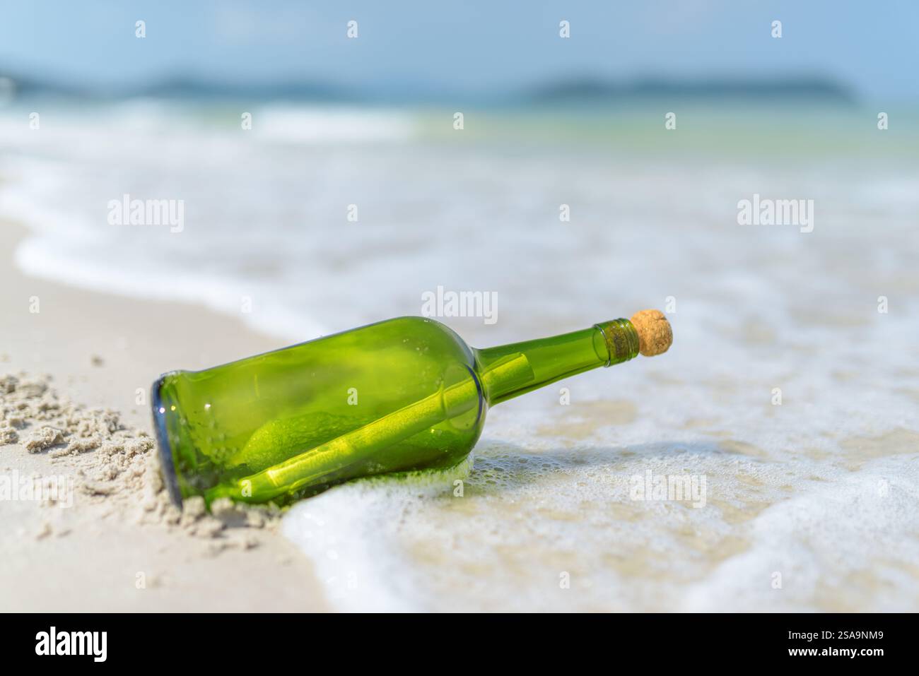Message in a bottle (MIB) on a sand beach Stock Photo