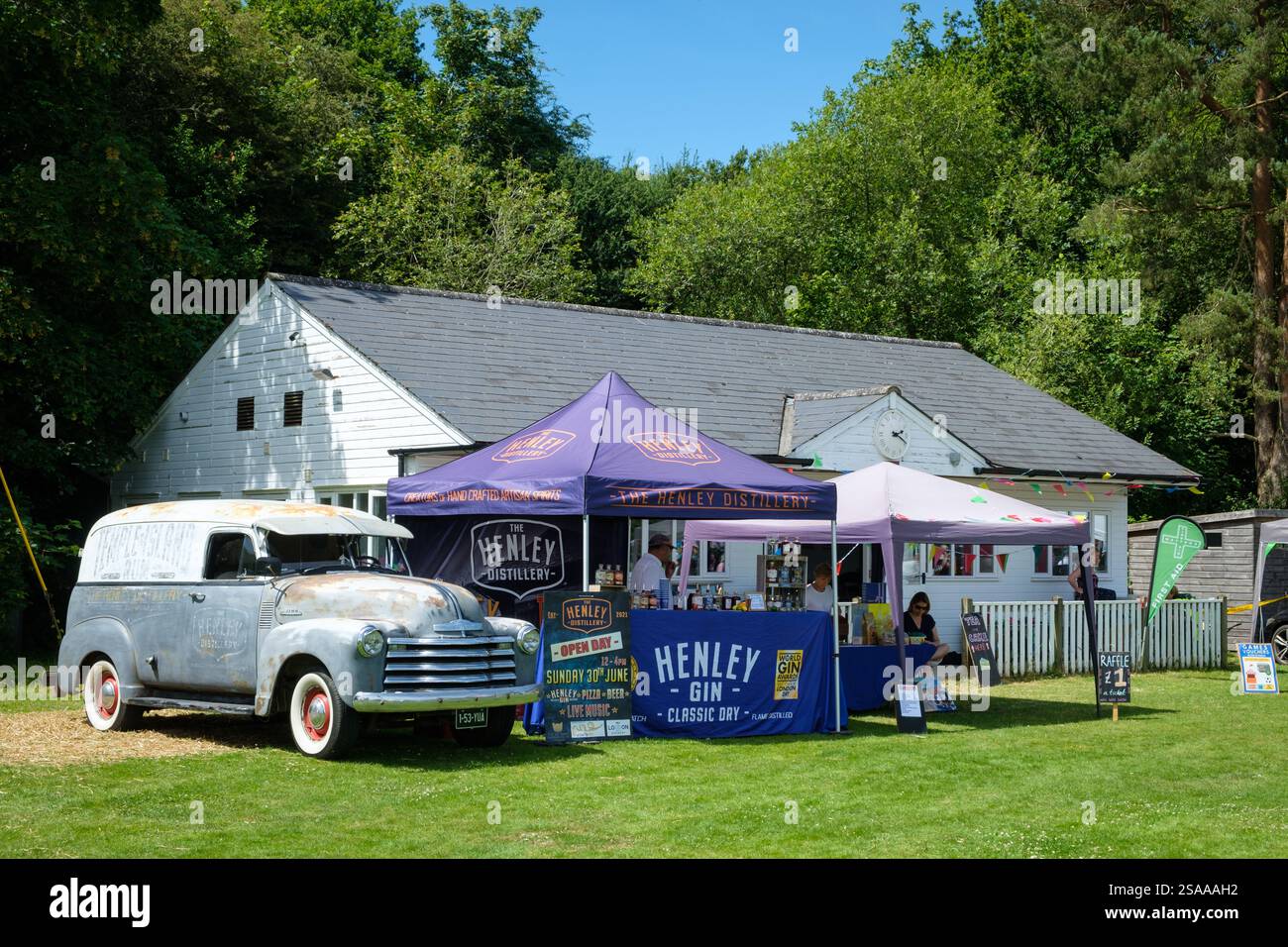 A stall for The Henley Distillery   at Nettlebed Fete with a classic vintage Chevrolet truck Stock Photo