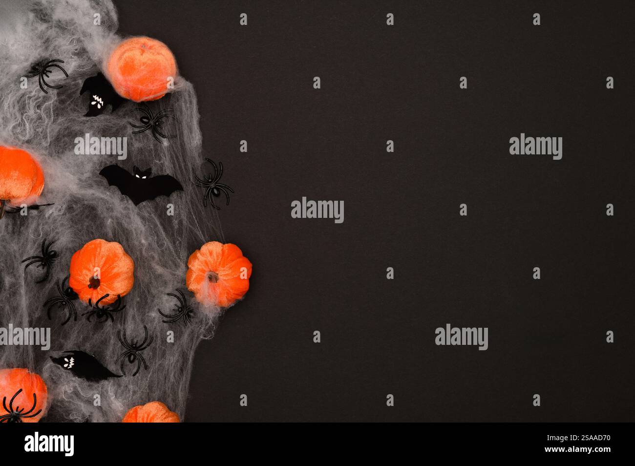 Layout of Halloween decorations on a black background: orange pumpkins ...
