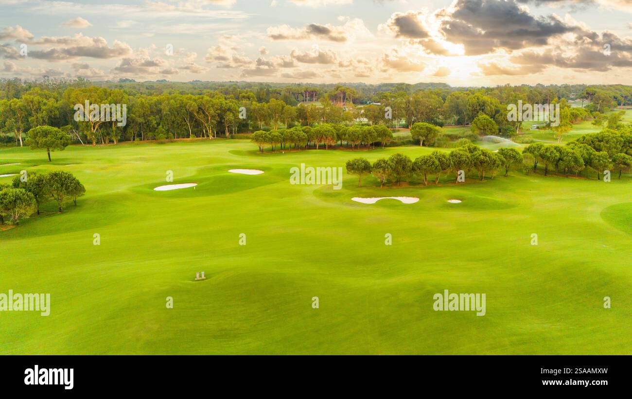 A stunning sunset view of a golf course with sand traps and vibrant ...