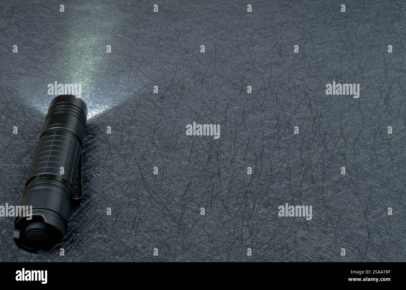 Flashlight shining on a black background. Nice copy space. Stock Photo