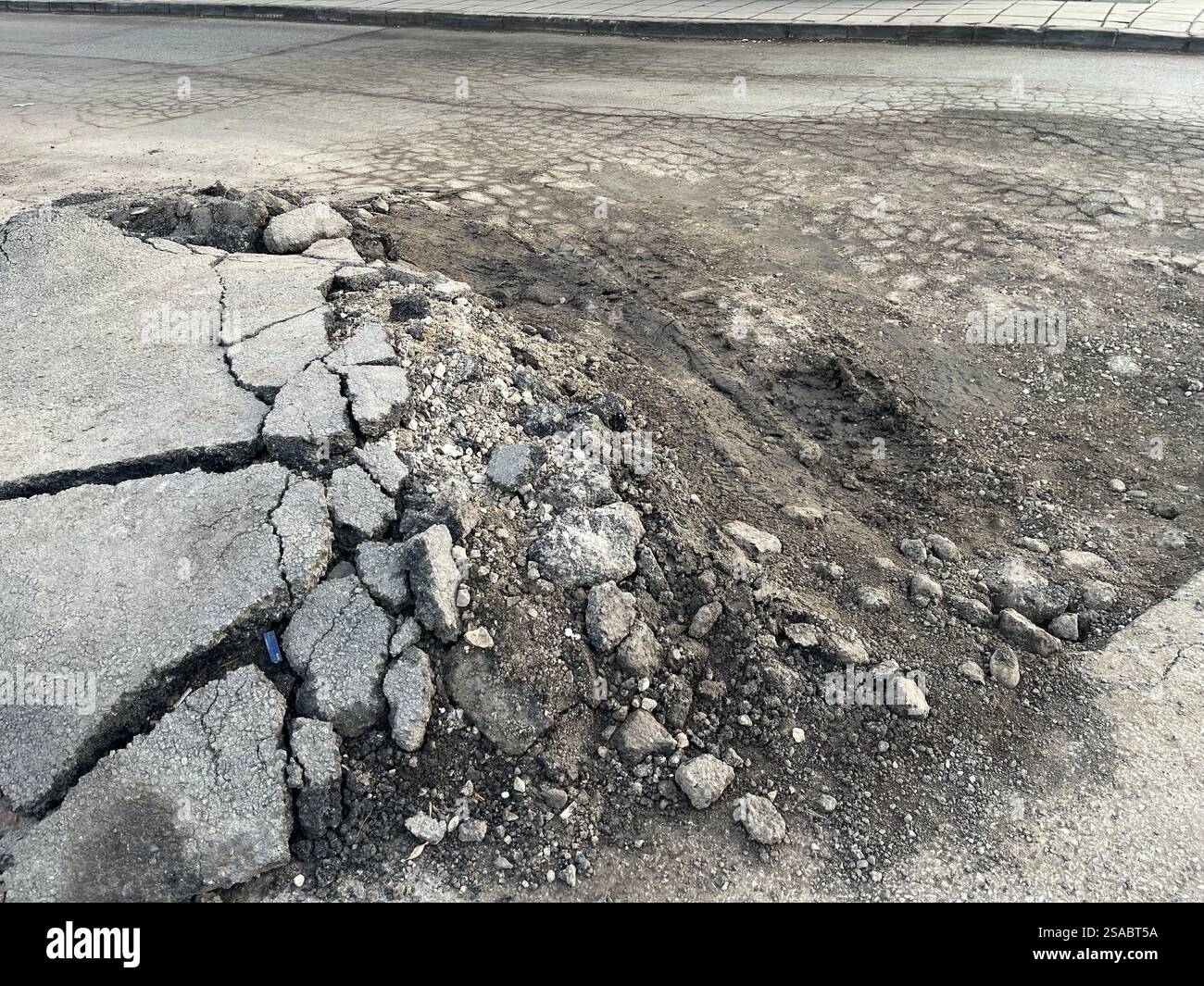 Pothole damaged low quality asphalt in Sofia Bulgaria, Eastern Europe, Balkans, EU - Smartphone Captured Stock Image