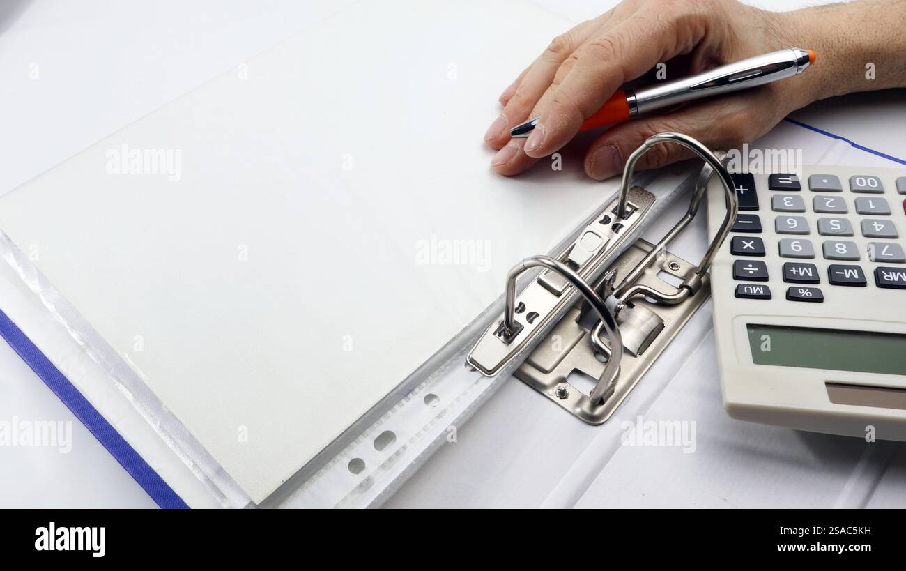 Binder for filing with blank page and man hand with pen, copy space ...