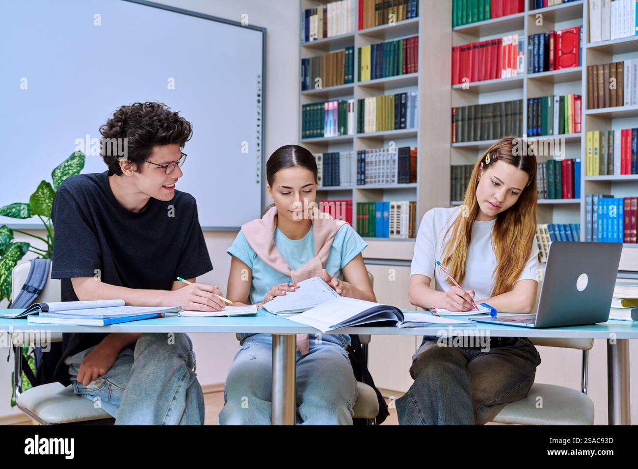 Group of high school students studying in library classroom Stock Photo ...