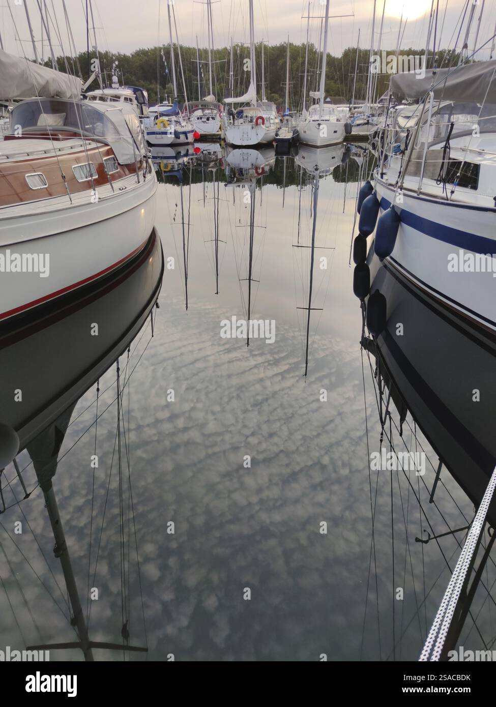Boats and clouds are reflected in the water Stock Photo - Alamy