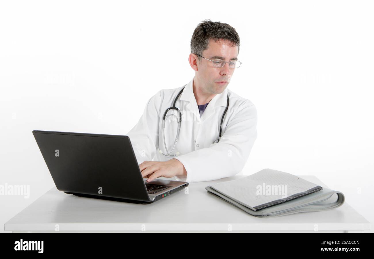 Medical Admin: Taking Notes. A doctor sitting at his desk transcribing ...
