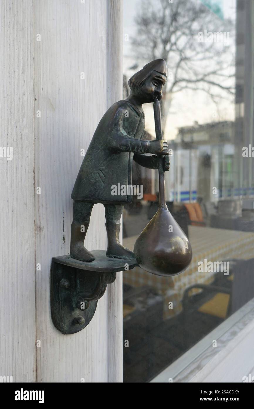 Door knocker glassblower figure Stock Photo