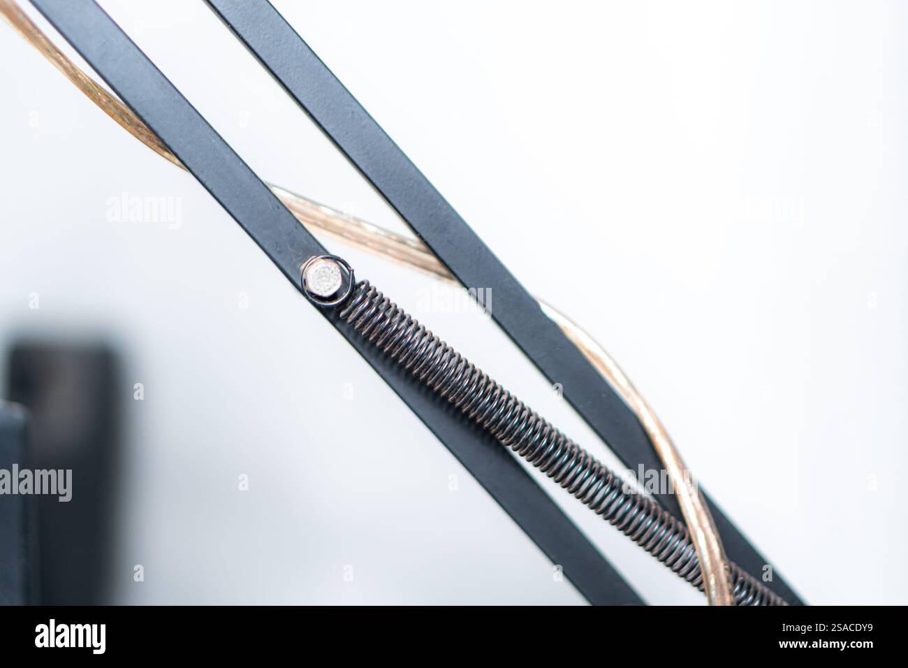 A close-up view of a mechanical arm with a textured cylindrical object ...