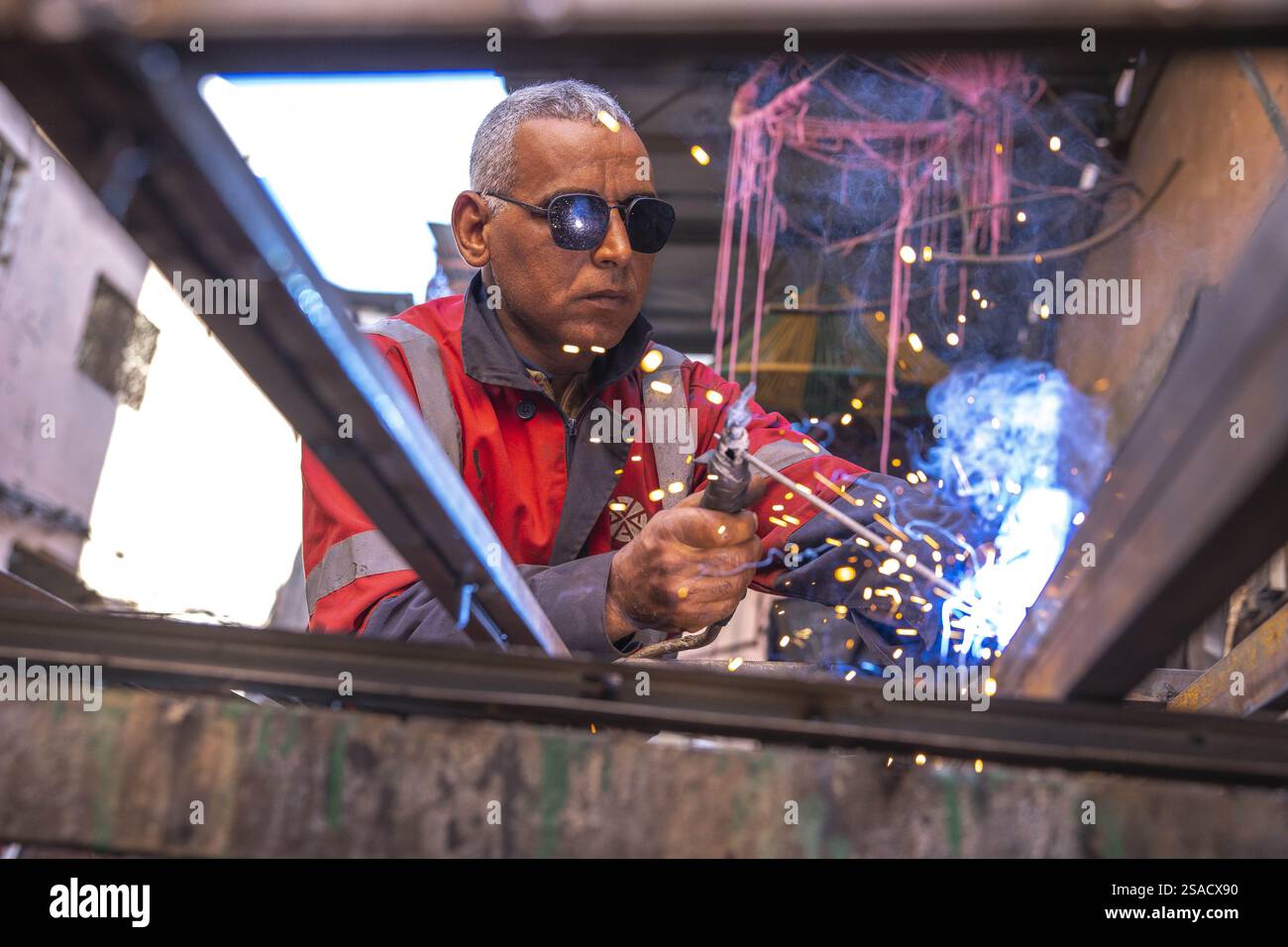 Welder at work in a workshop in Marrakesh, Morocco Stock Photo