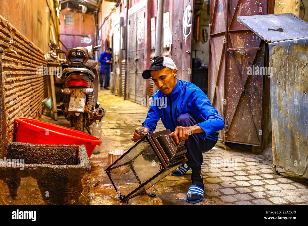 Craftsman at work outside a workshop in Marrakesh, Morocco Stock Photo