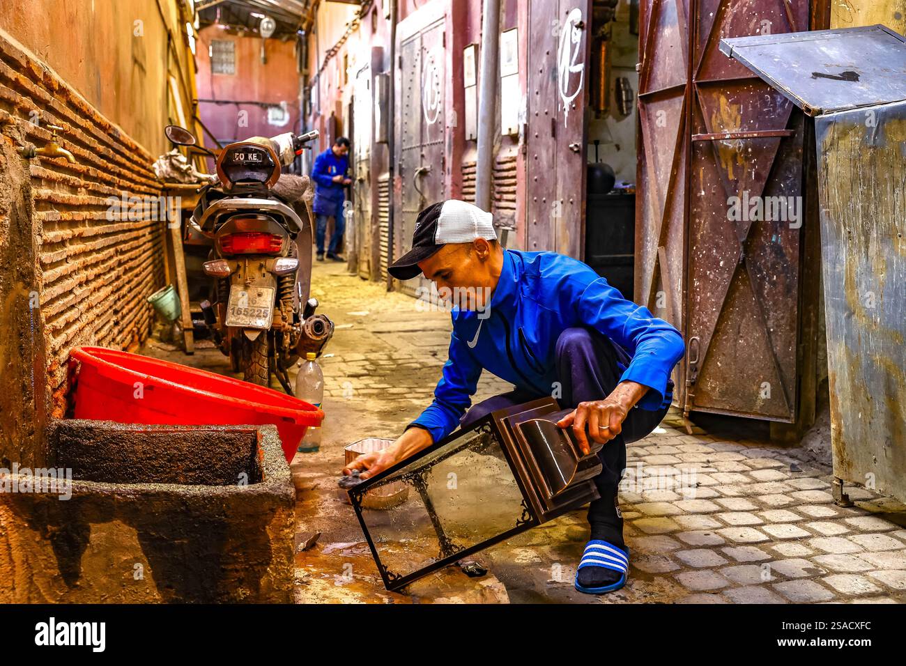 Craftsman at work outside a workshop in Marrakesh, Morocco Stock Photo