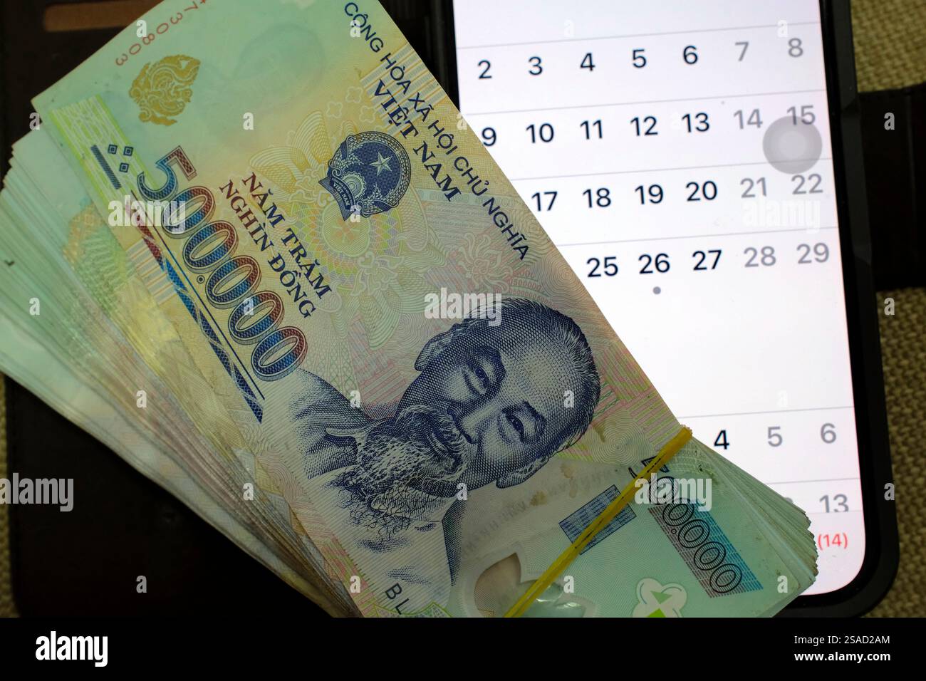 Vietnamese money with a monthly calendar Repayment of a loan Money Vietnamese money with a monthly calendar Repayment of a loan Money