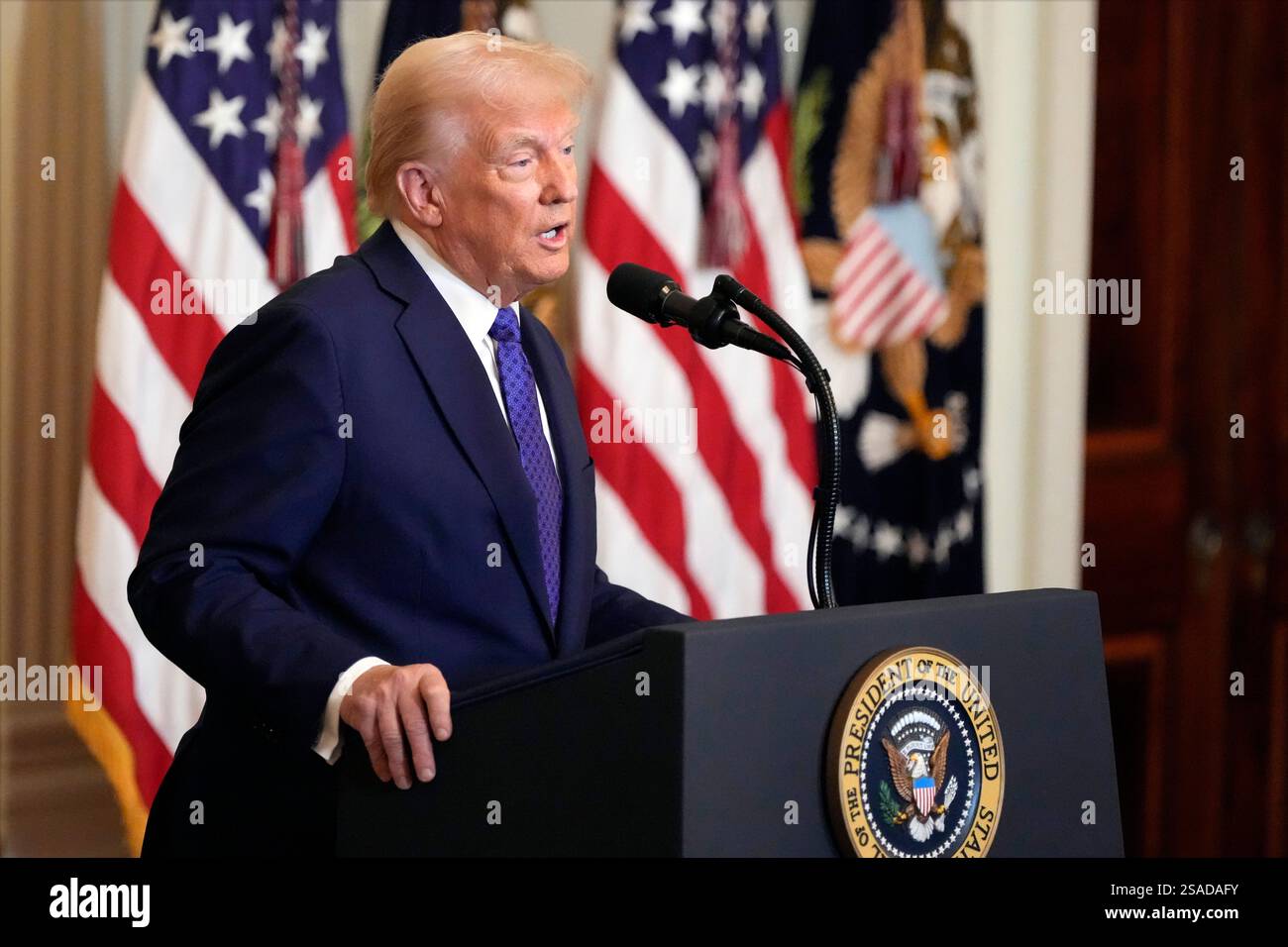 President Donald Trump speaks before signing the Laken Riley Act in the ...