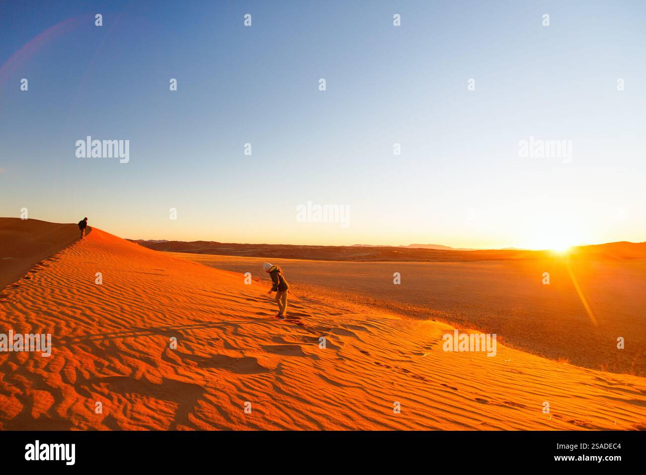 Kids having fun during sunset in red sand dunes in Namib desert Stock ...