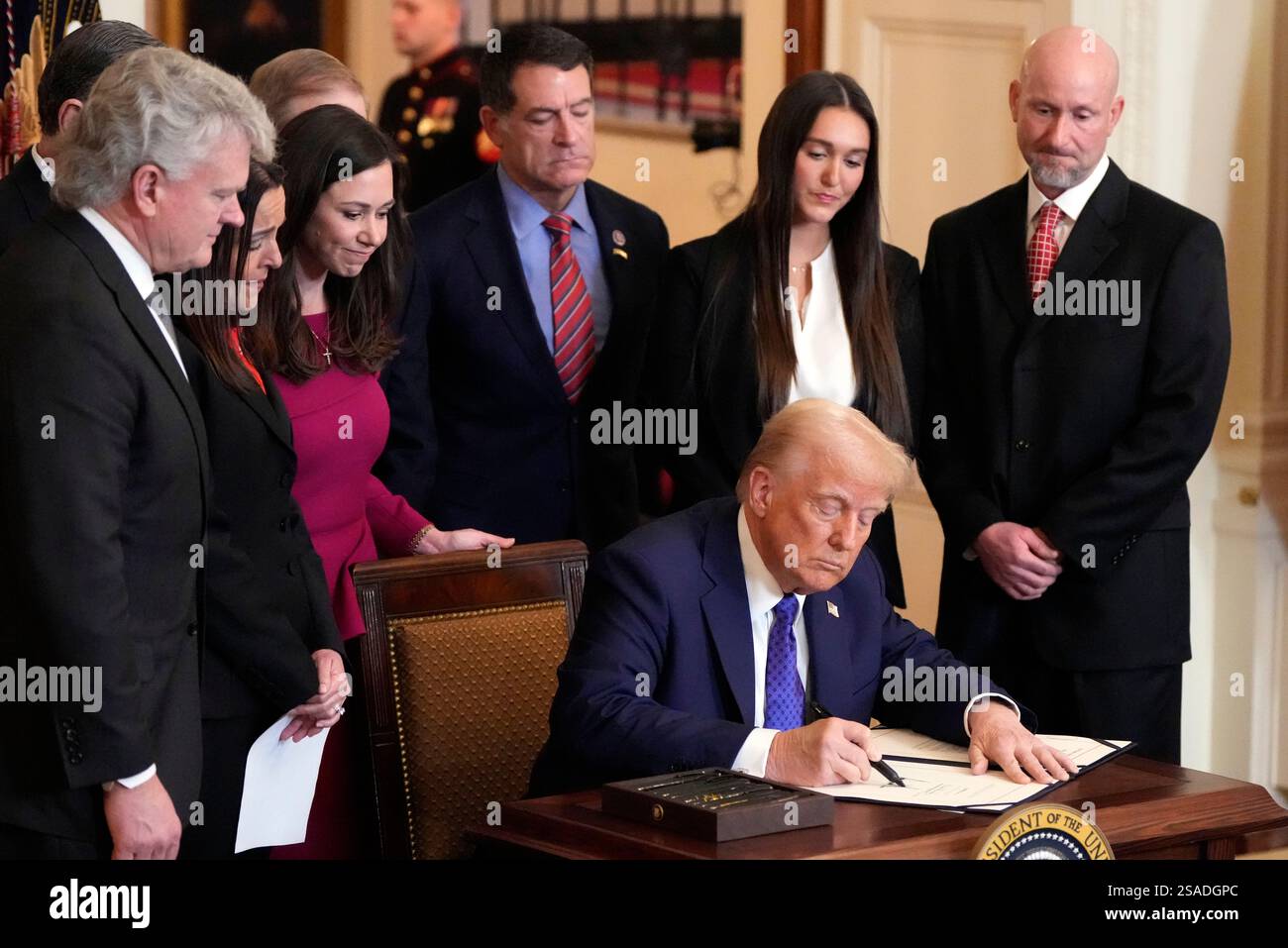 President Donald Trump signs the Laken Riley Act during an event in the ...