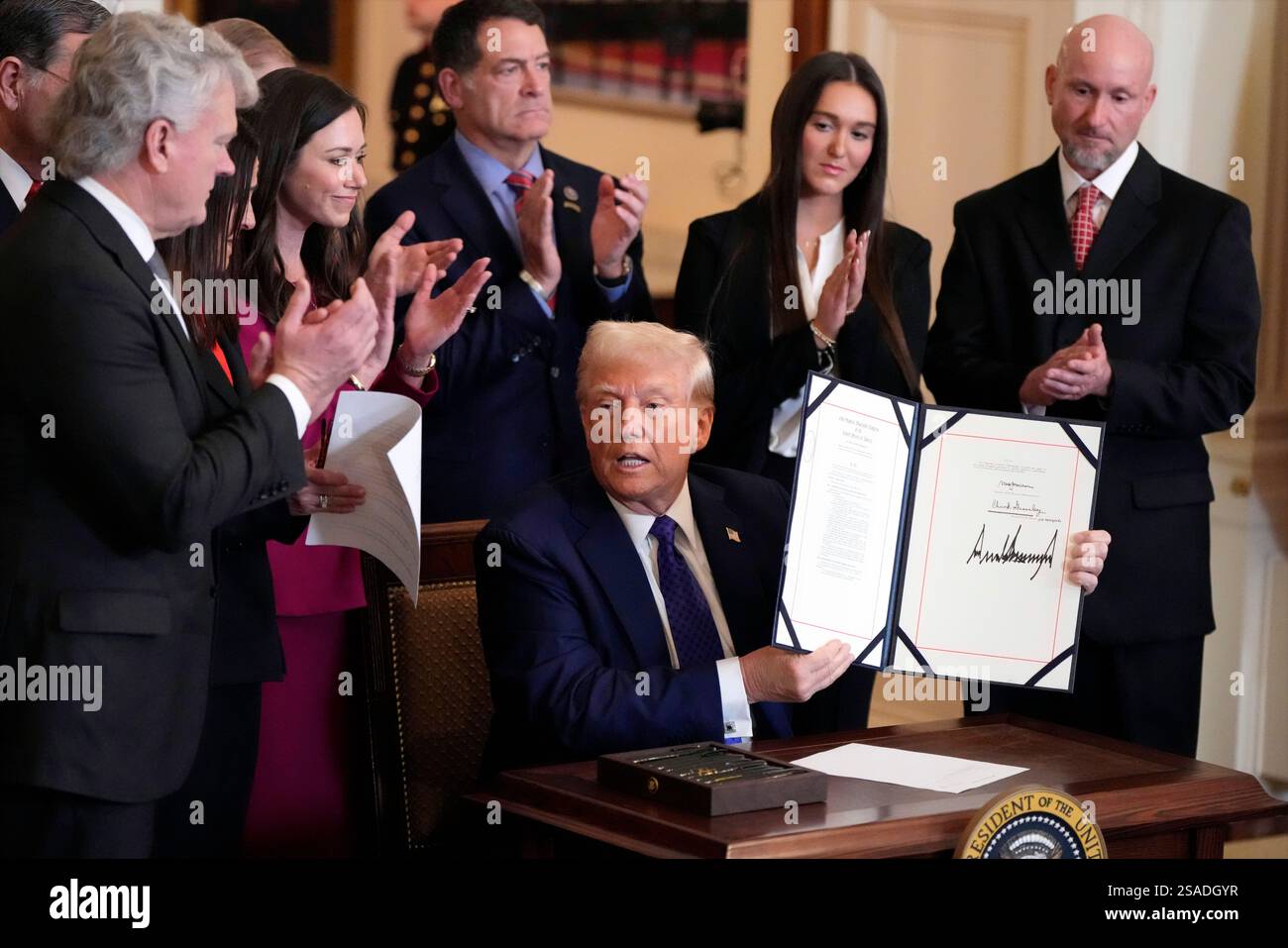 President Donald Trump signs the Laken Riley Act during an event in the ...
