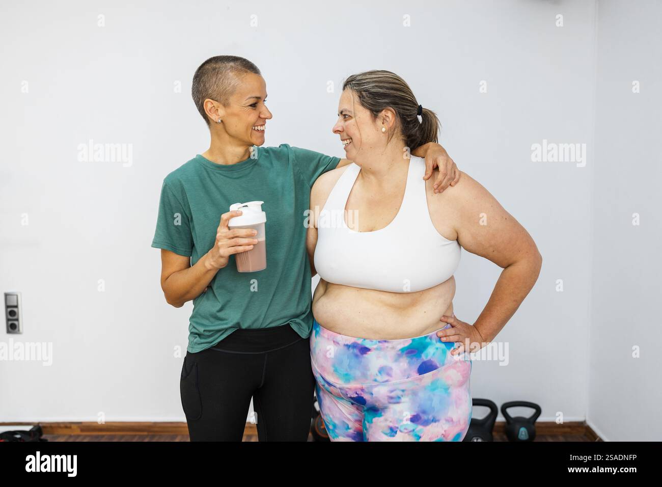 Personal Trainer Supporting Client With Protein Shake After Workout personal-trainer-supporting-client-with-protein-shake-after-workout