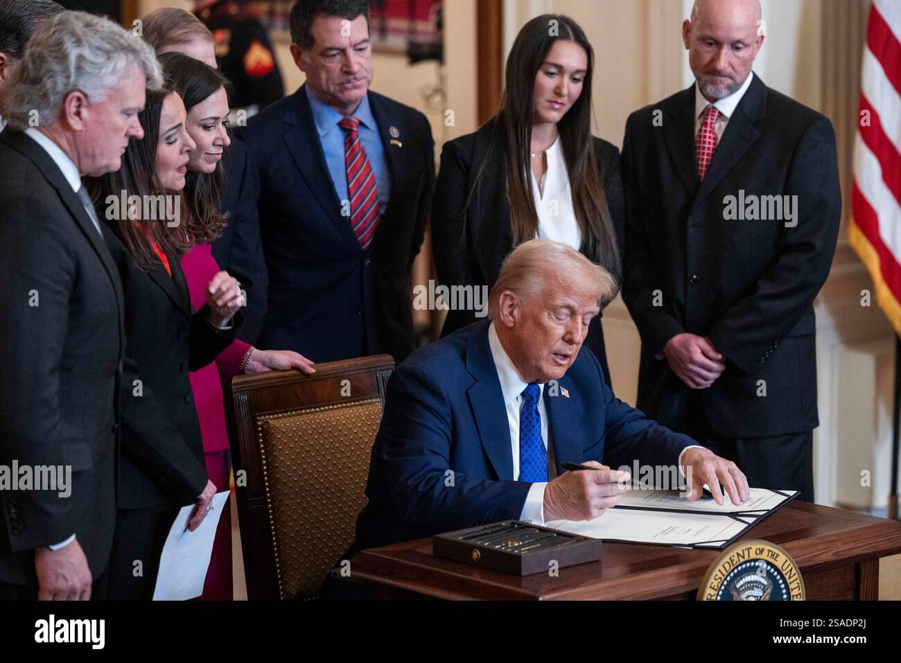 US President Donald Trump signs the Laken Riley Act in the East Room of ...