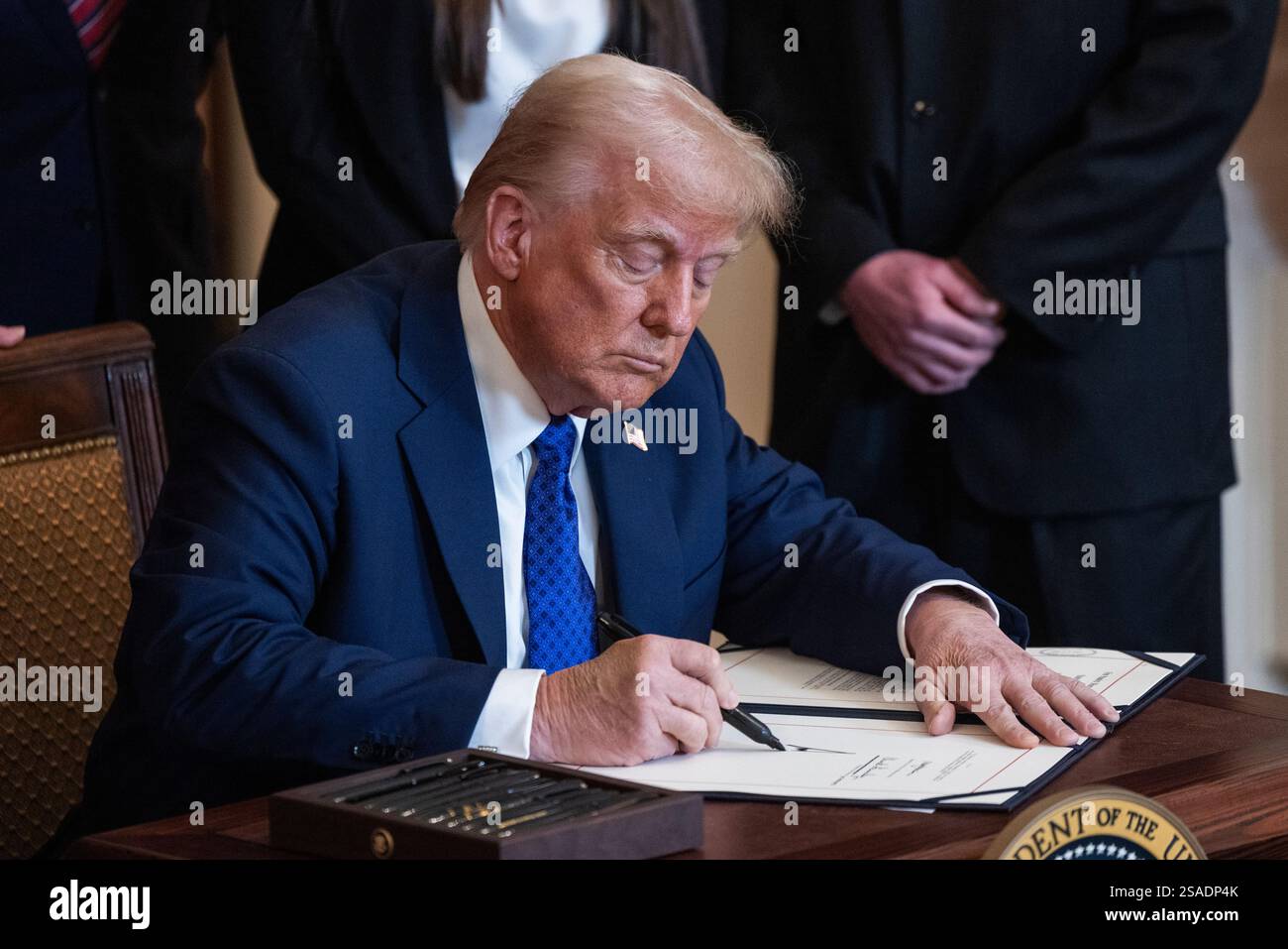 US President Donald Trump signs the Laken Riley Act in the East Room of ...
