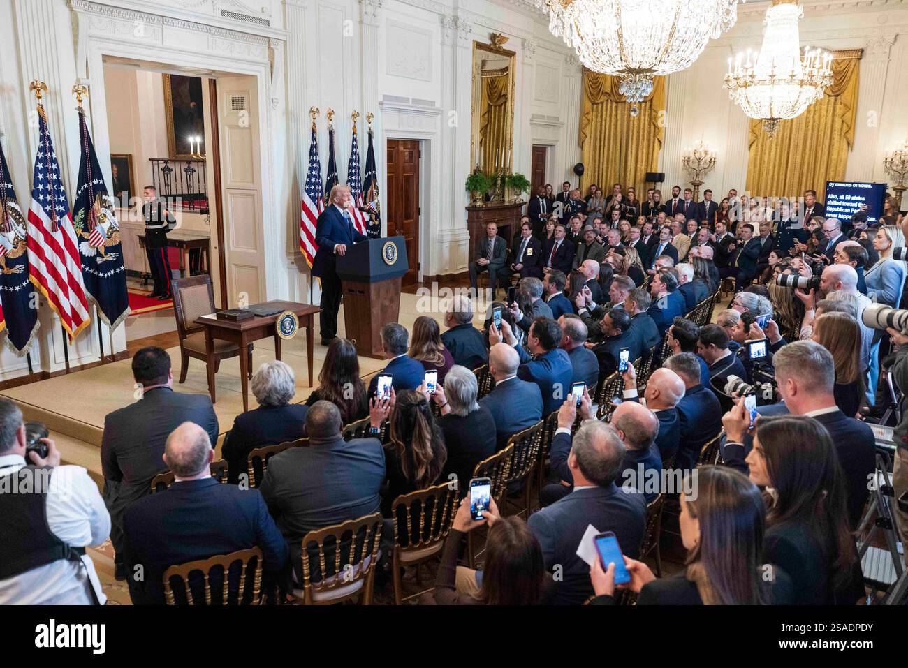 US President Donald Trump (L) speaks before signing the Laken Riley Act ...