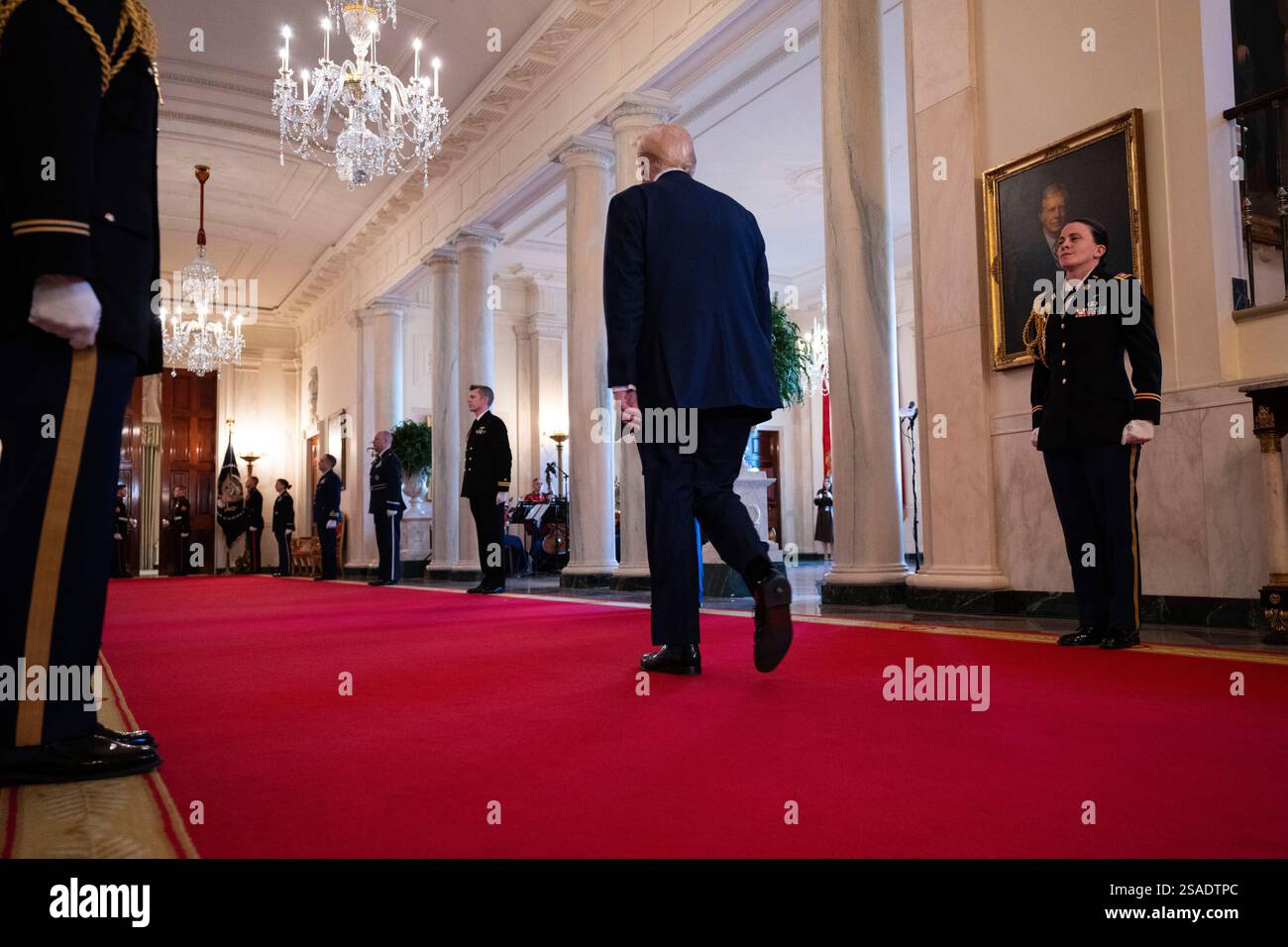 President Donald Trump walks off after signing the Laken Riley Act ...