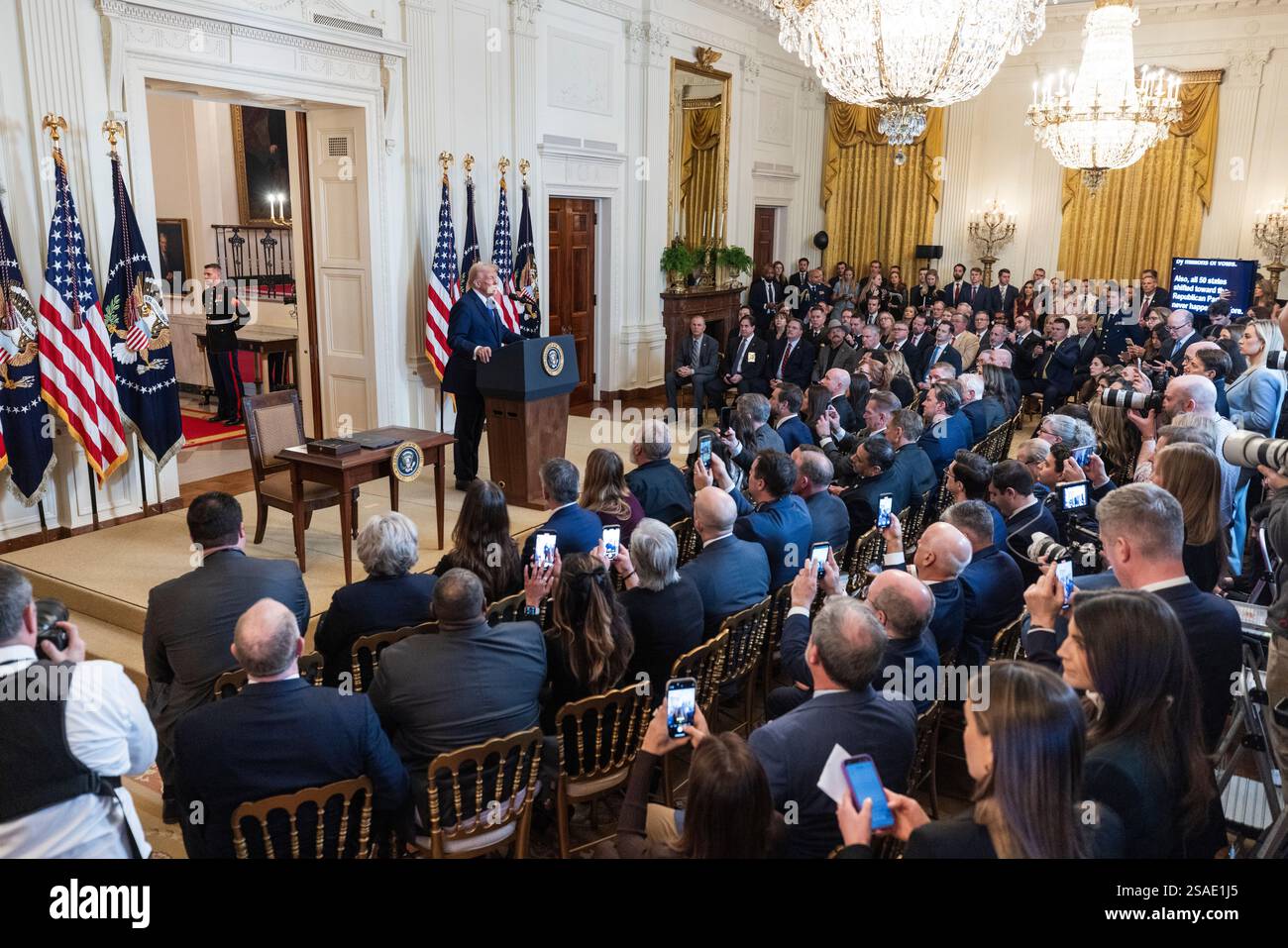 US President Donald Trump (L) speaks before signing the Laken Riley Act ...