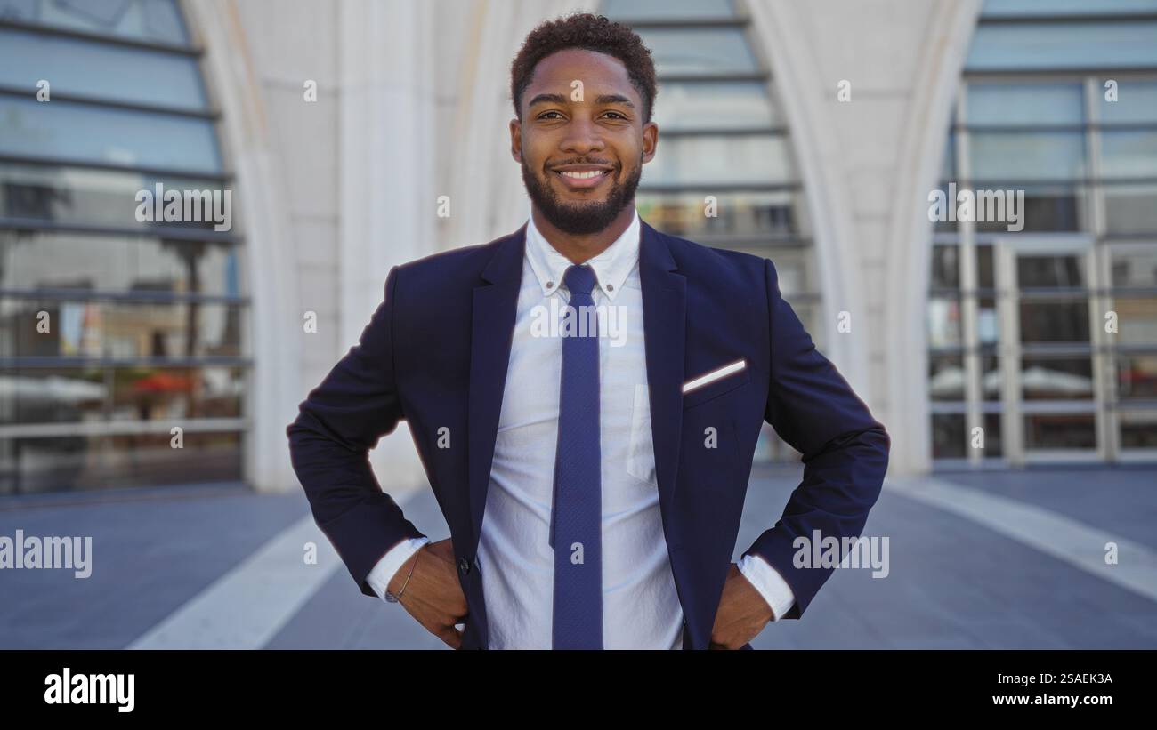 Handsome young african man in a suit smiling confidently standing ...