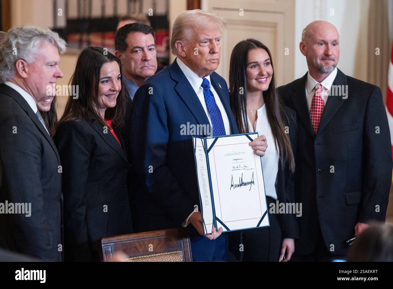 United States President Donald Trump holds the Laken Riley Act after he ...