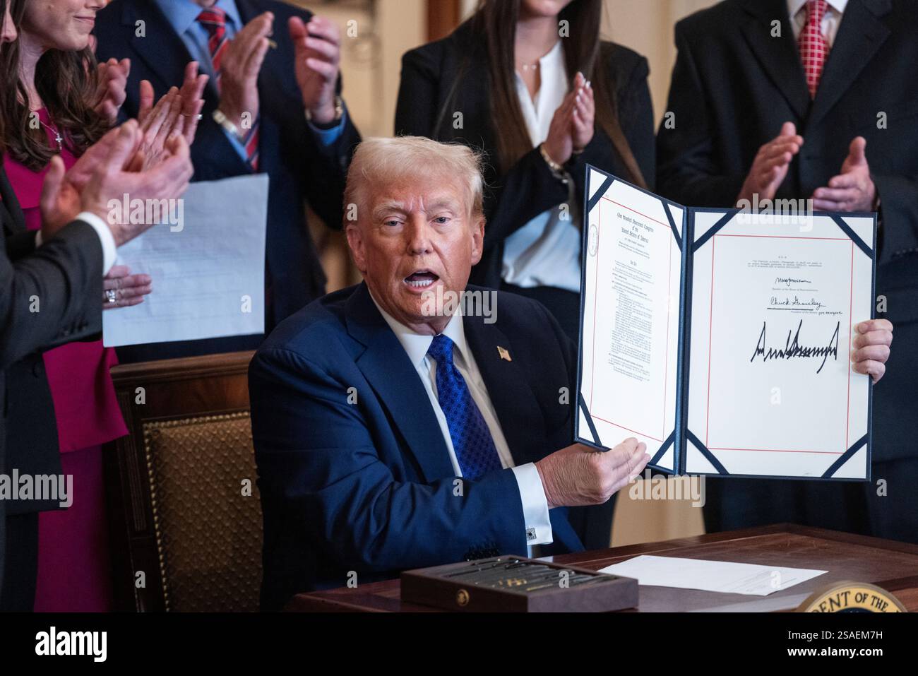United States President Donald Trump raises the Laken Riley Act after ...