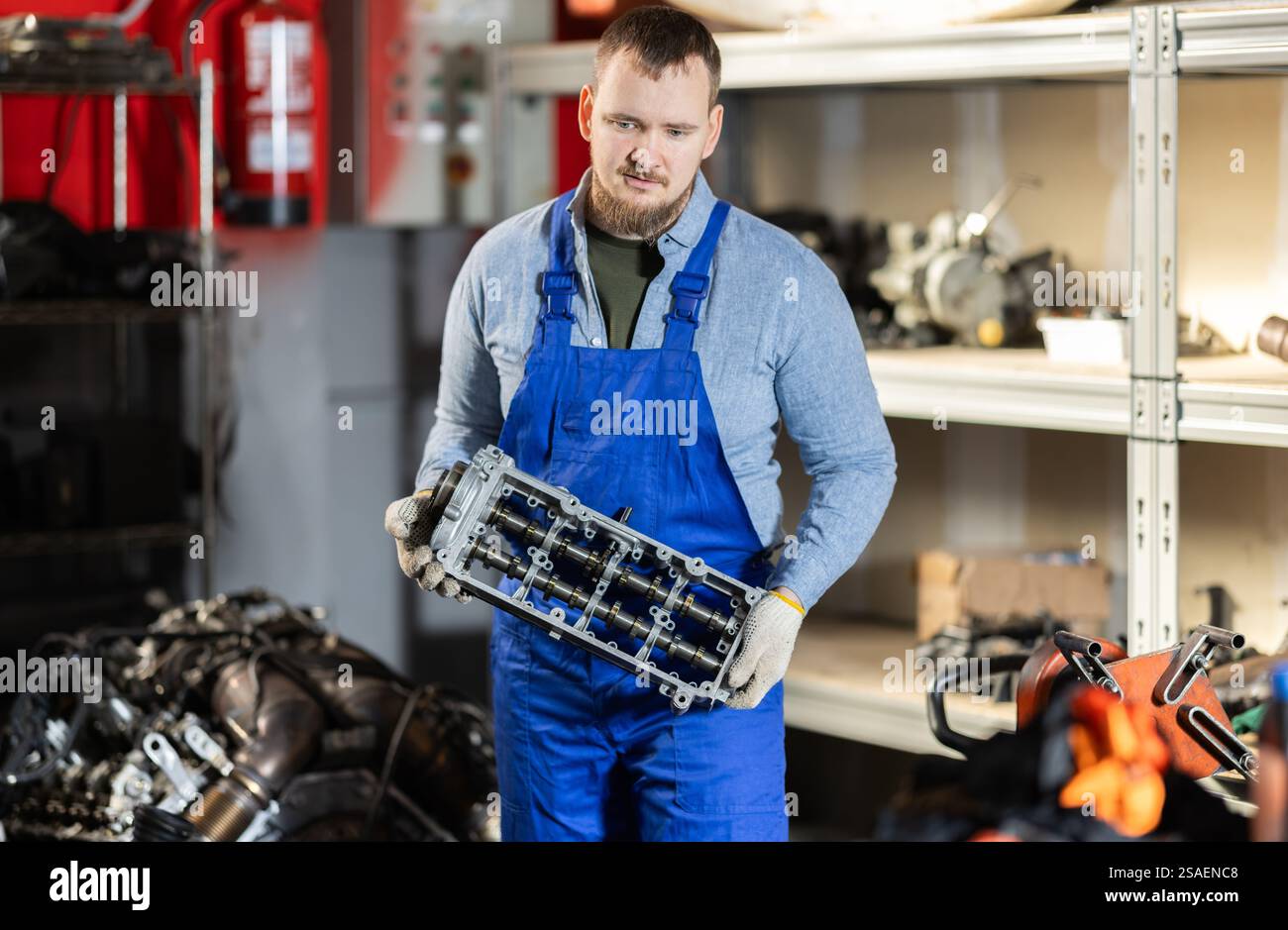Man professional auto mechanic repairing car engine in garage Stock ...