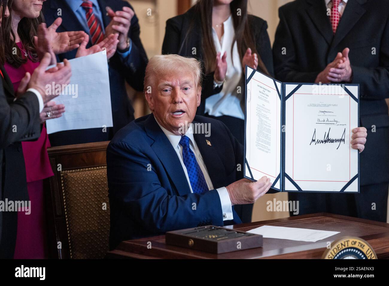 United States President Donald Trump raises the Laken Riley Act after ...