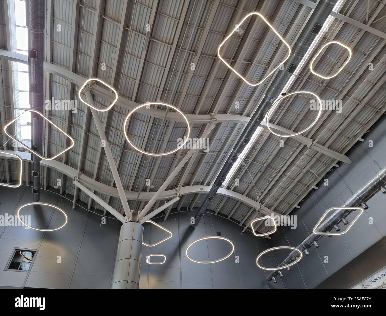 Interior of the new terminal of Odesa International airport (ODS / UKOO) in Ukraine with decorative lights at the ceiling - Smartphone Captured Stock Image