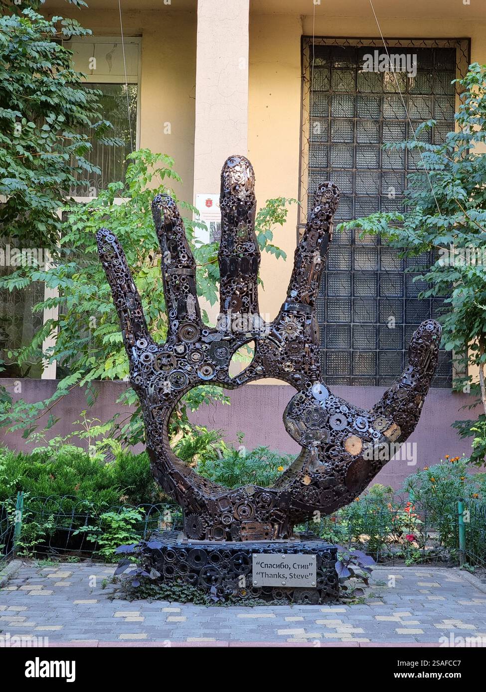 The Monument to Steve Jobs in Odesa (Odessa ), Ukraine; a hand comprised of many metal gear wheels and other parts; tribute to innovation - Smartphone Captured Stock Image
