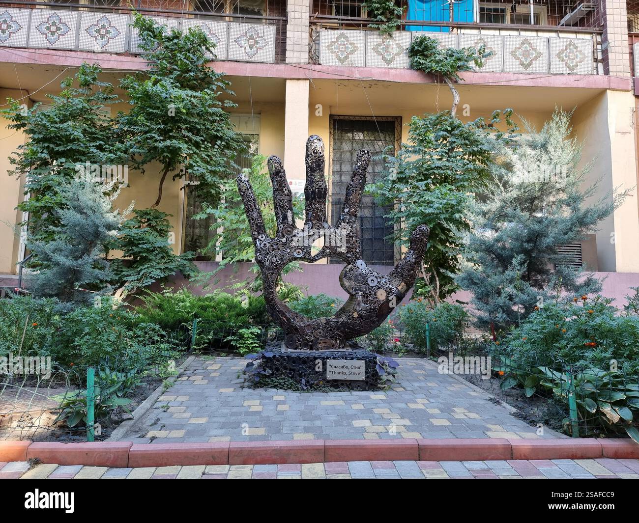 The Monument to Steve Jobs in Odesa (Odessa ), Ukraine; a hand comprised of many metal gear wheels and other parts; tribute to innovation - Smartphone Captured Stock Image