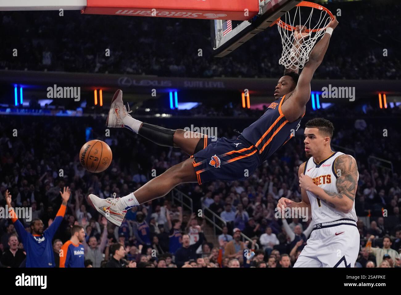 New York Knicks' OG Anunoby, center, dunks the ball in front of Denver ...