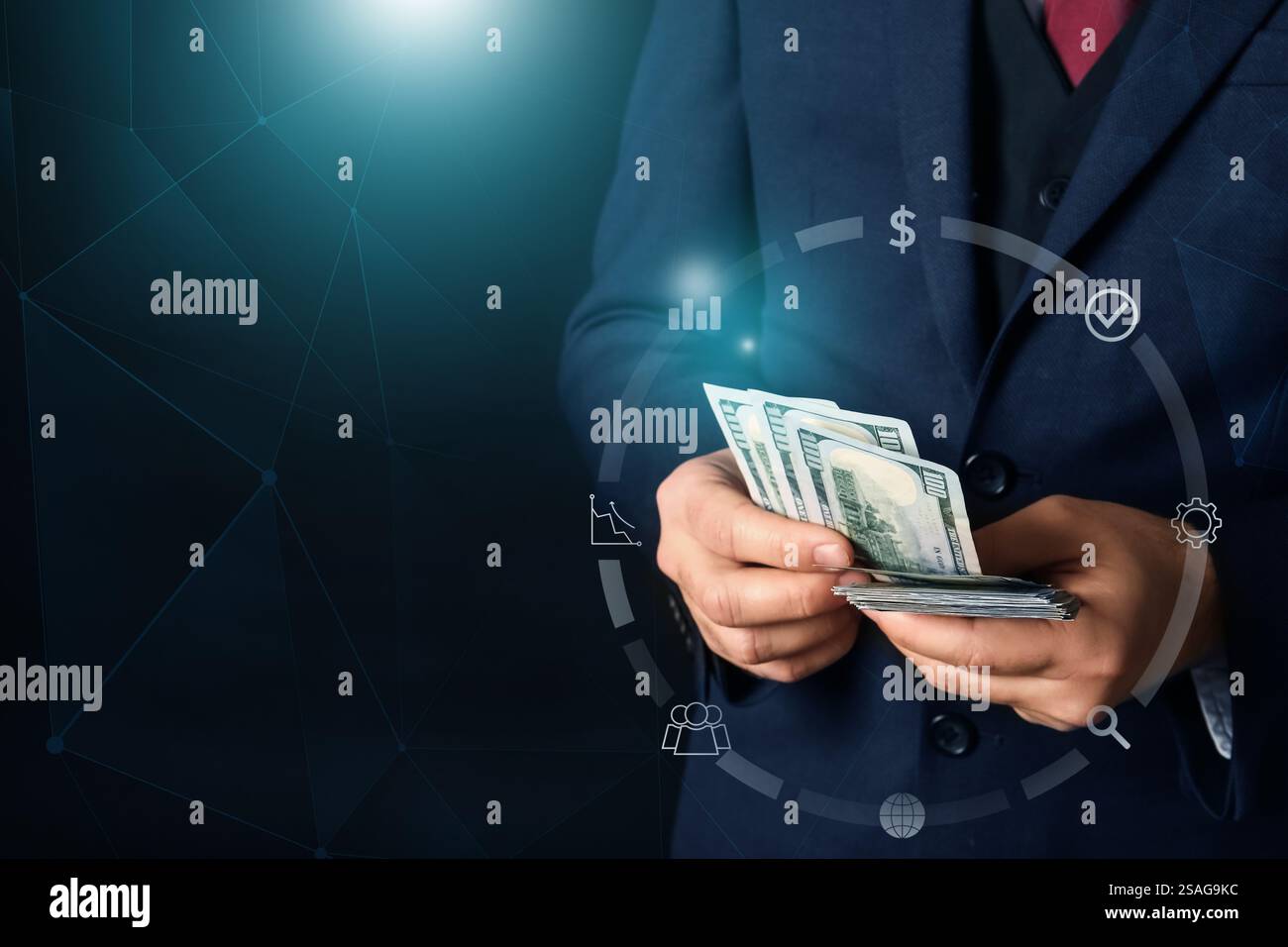 Young businessman with money on dark background. Concept of goals Stock Photo