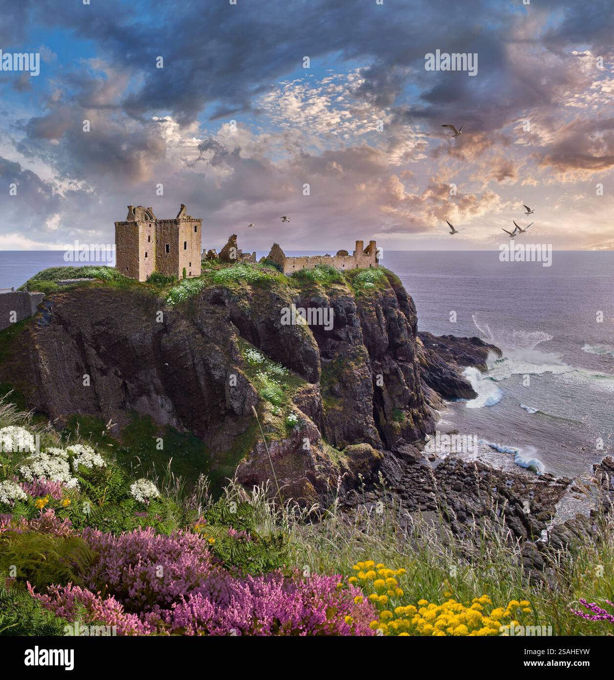 The picturesque medieval Dunnottar Castle ruins on the cliff top overlooking the sea at sunset, Scotland. Stock Photo