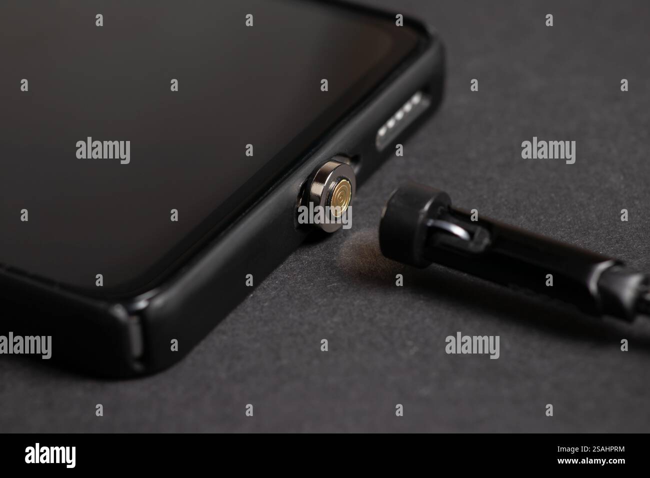 Magnetic cable for charging smartphone, close up Stock Photo