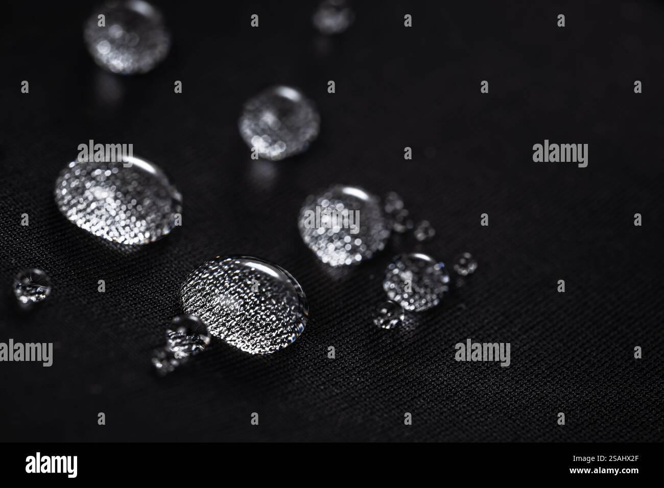 Many water drops on waterproof impregnated fabric. Stock Photo