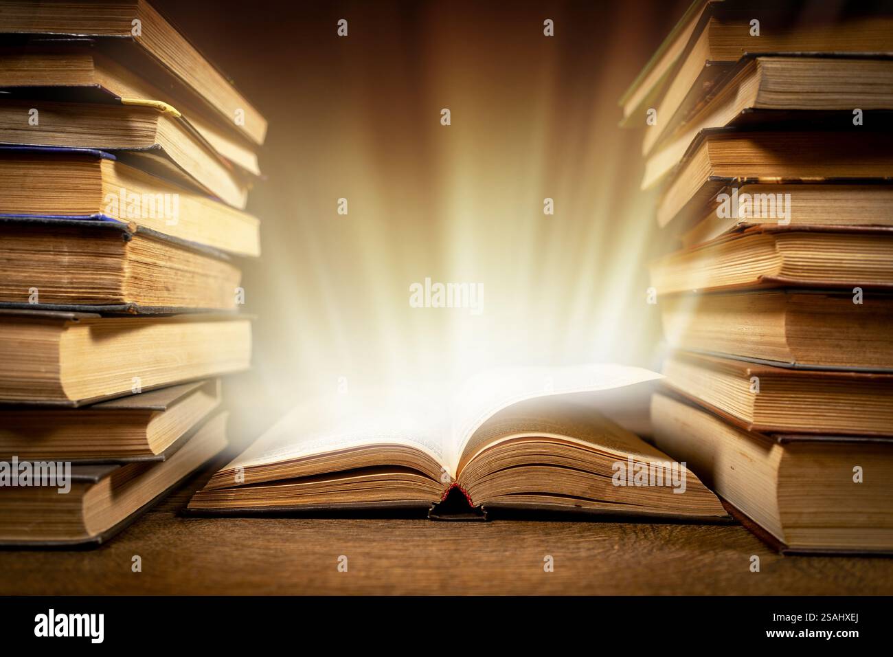 Old Book With Magic Lights On Vintage Table. Stock Photo