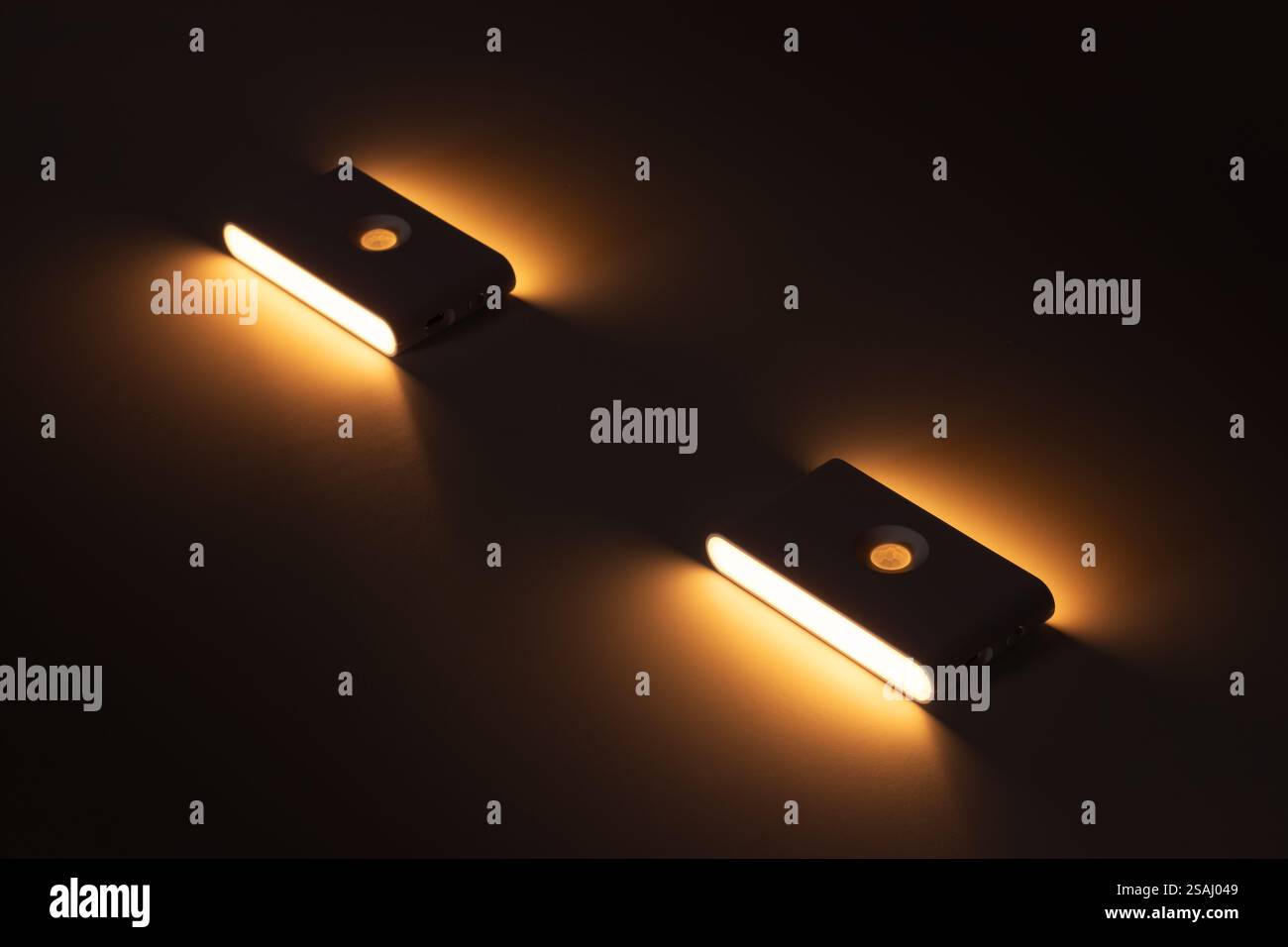 Two small solar night led light with motion sensor on wall Stock Photo