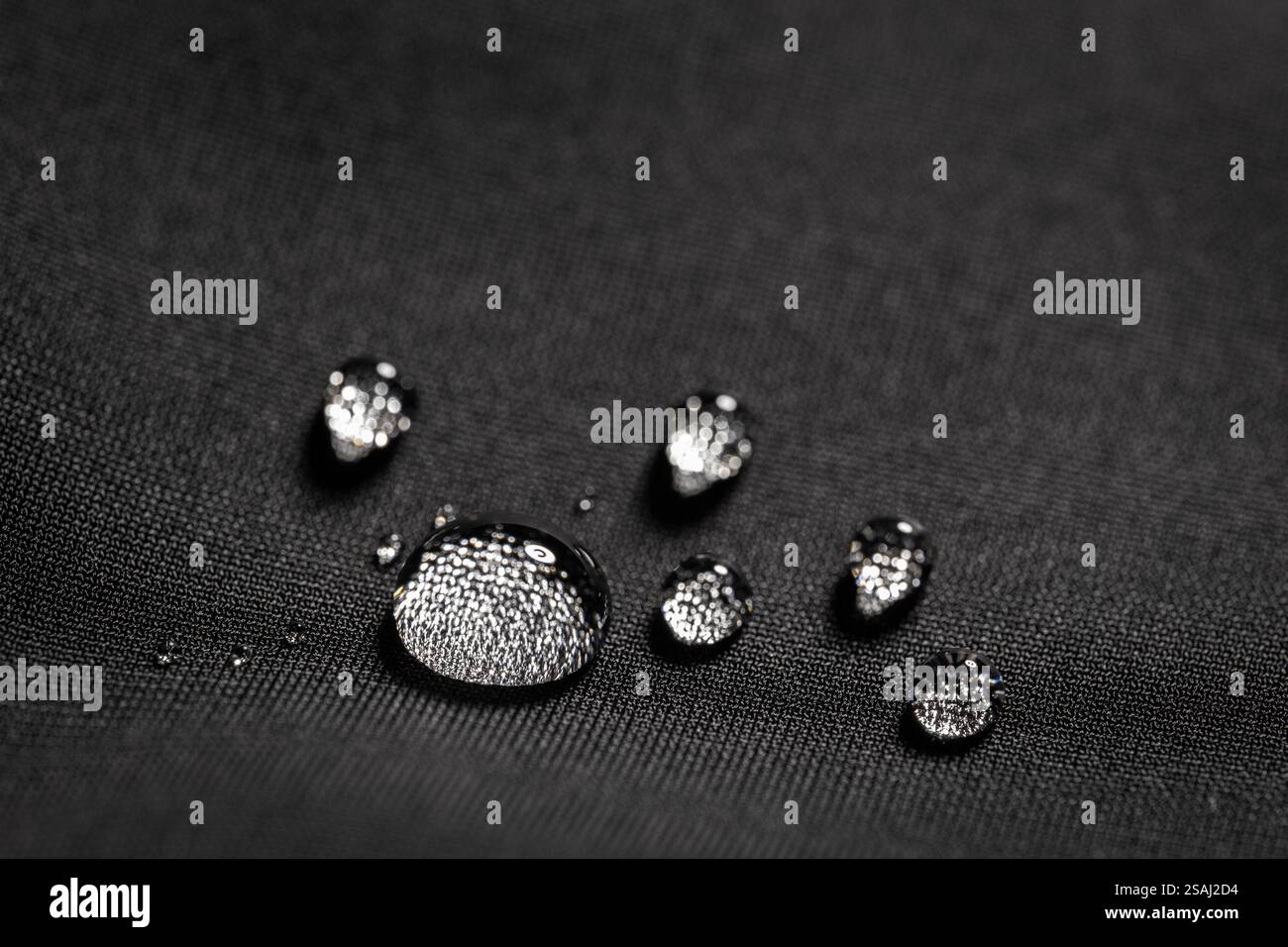 Many water drops on waterproof impregnated fabric. Stock Photo