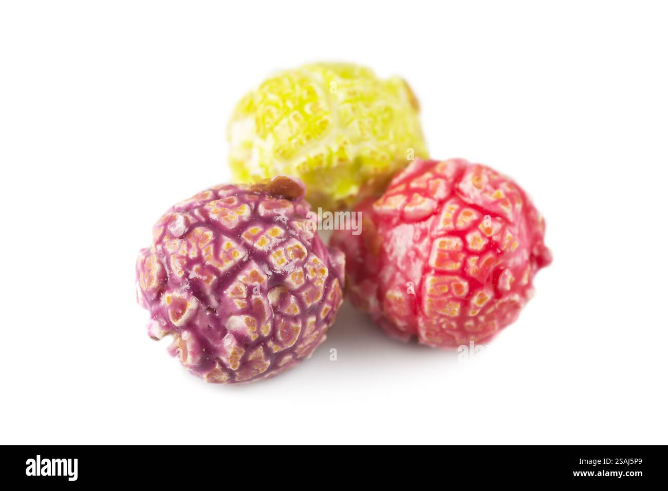 Colored fruity popcorn isolated on white background. Stock Photo