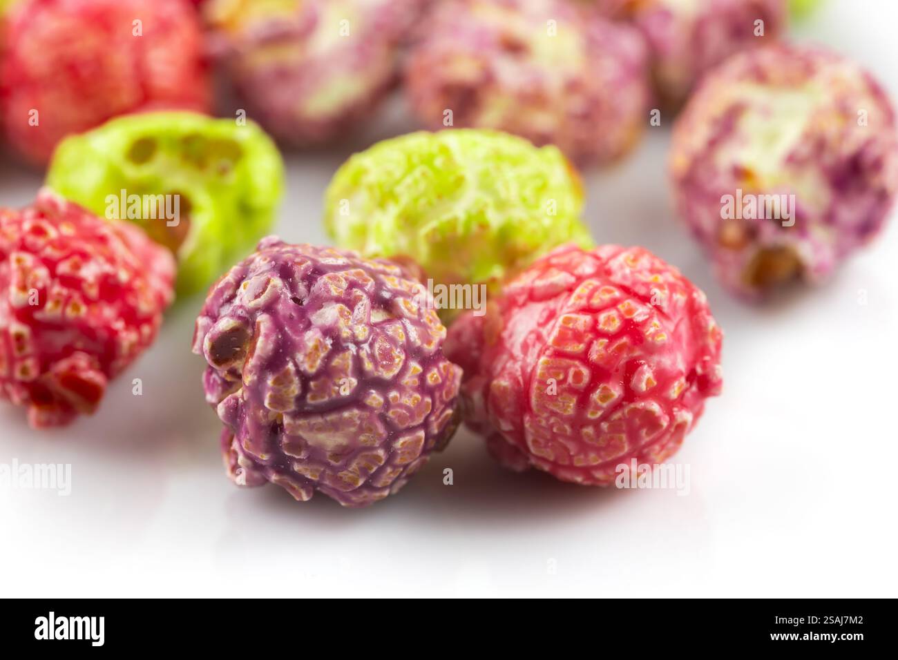Colorful popcorn on white background close up. Stock Photo