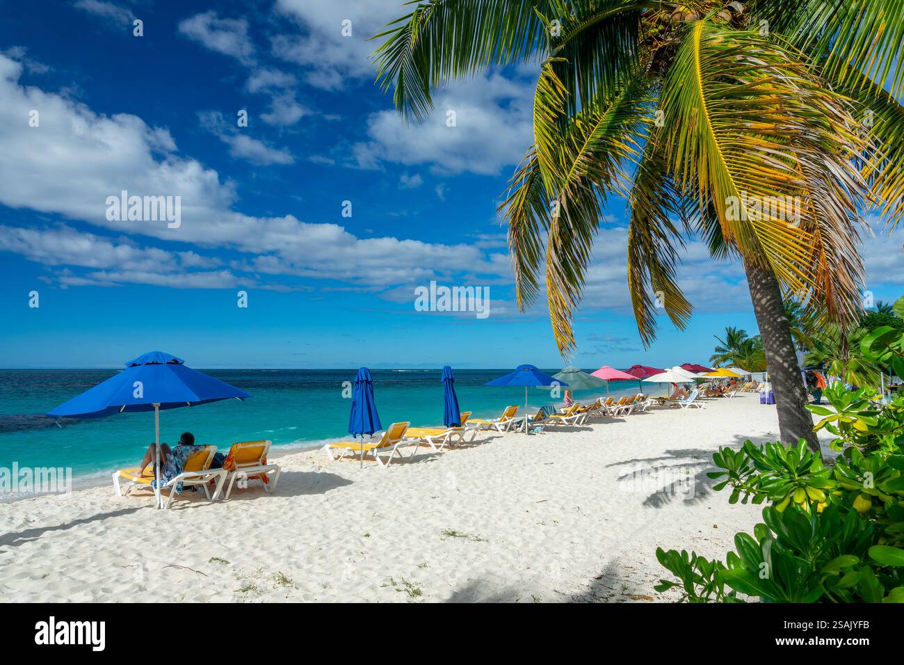 People and parasols in Shoal Bay beach, Caribbean dream landscape in ...